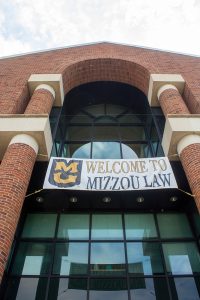 a picture of hulston hall with a sign saying welcome to mizzou law