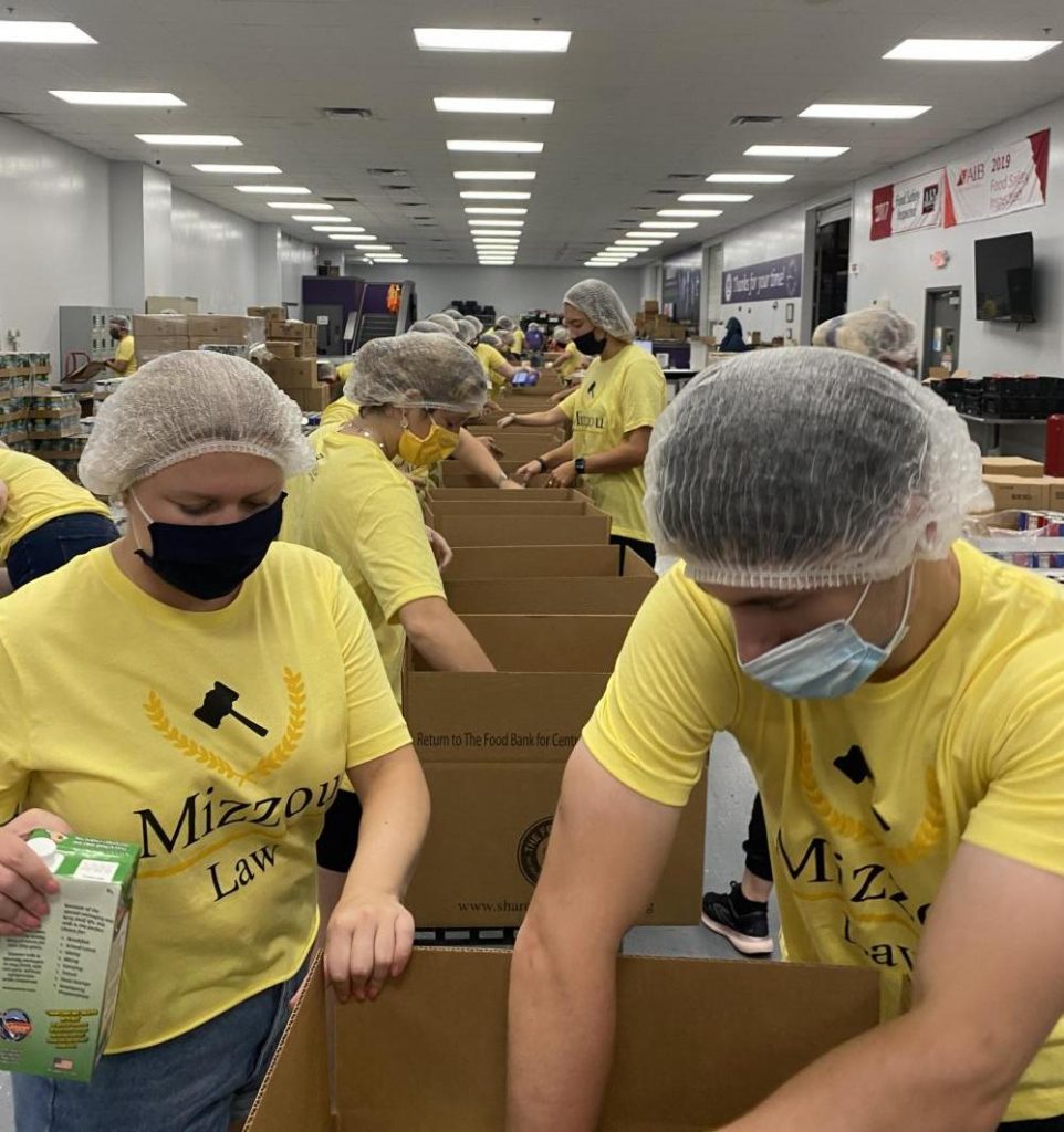 a group of students volunteering at the food bank