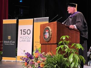 a photo of a speaker at graduation