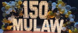 a photo of a lit up sign saying 150 MU Law