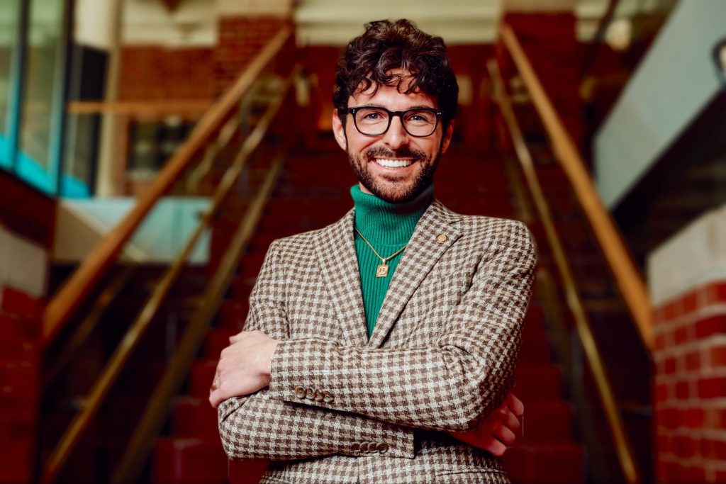 a photo of brandon bethel standing by the hulston stairs