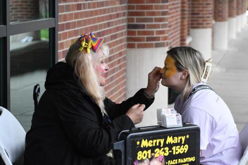 a photo of a girl getting her face painted