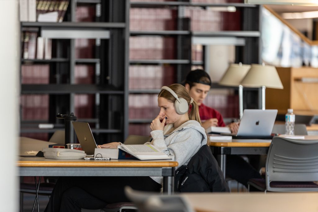 a photo of two students studying in the library