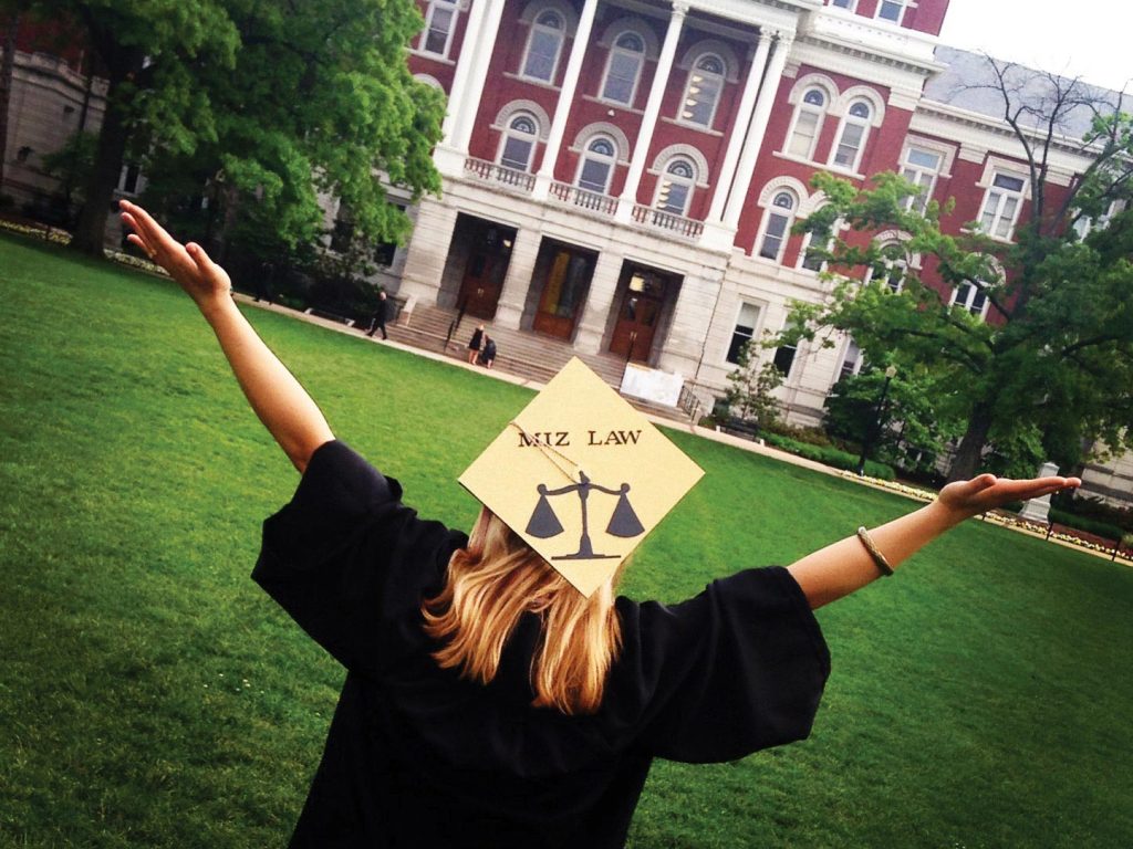 a photo of a student with a graduation cap saying miz law on it celebrating