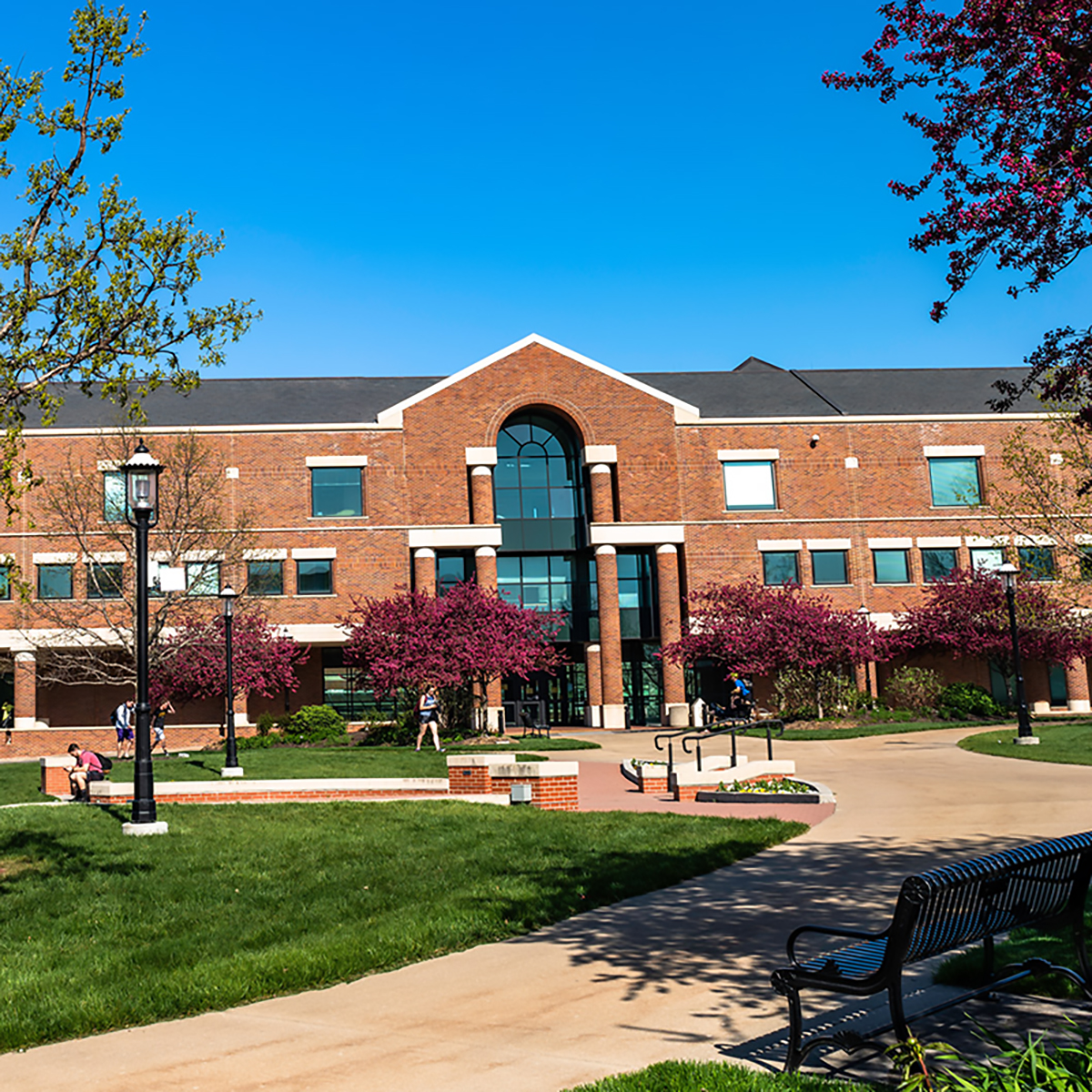 a photo outside hulston hall in the spring