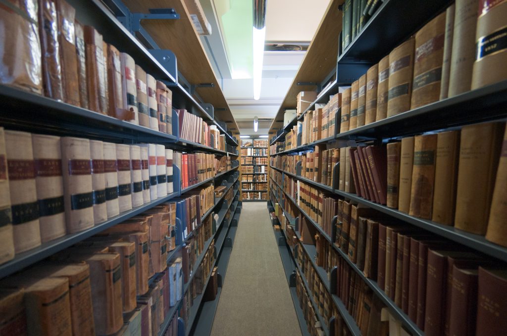 aisle between bookshelves full of books