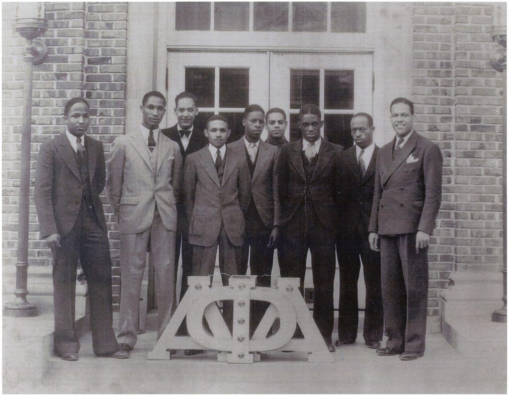 a photo of lloyd gaines with a group of other black men in suits