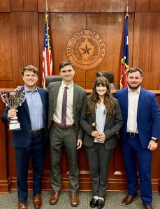 four mizzou law students posing with their trophy