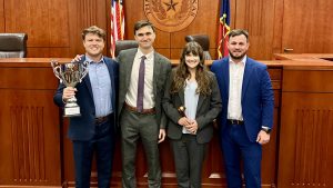 four mizzou law students posing with their trophy