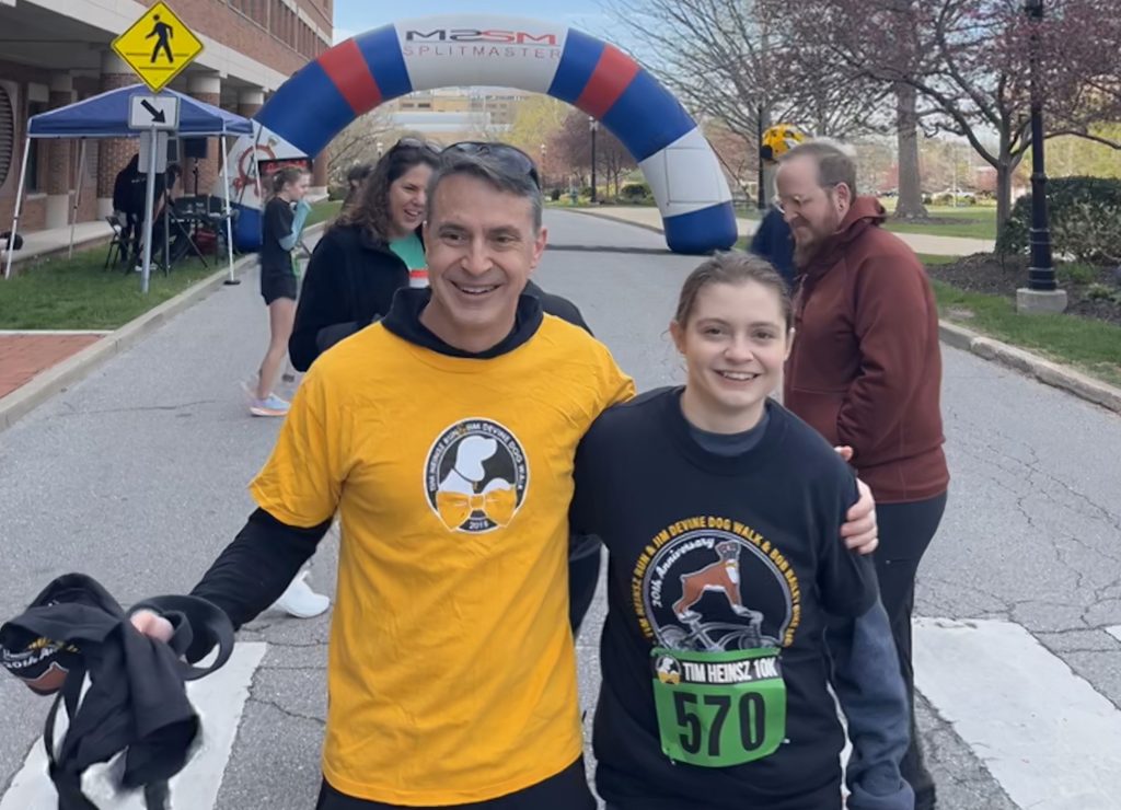 the adamsons in front of the finish line of the tim heinsz race