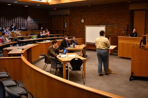 A CPC student interviews a police officer in a mock hearing