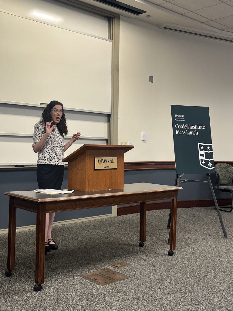 professor lietzan speaking at a podium