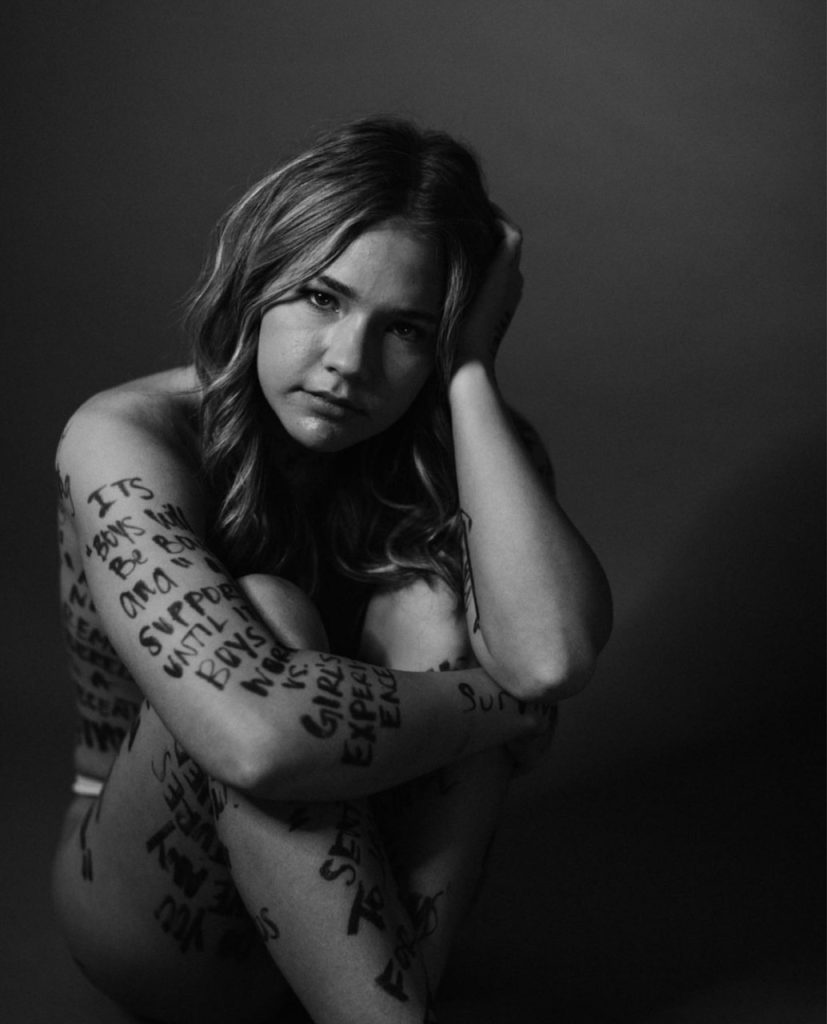 tabitha crain posing for her exhibit supporting domestic assault survivors
