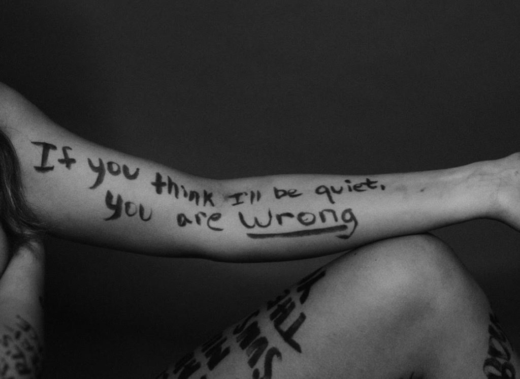 tabitha crain posing for her exhibit supporting domestic assault survivors