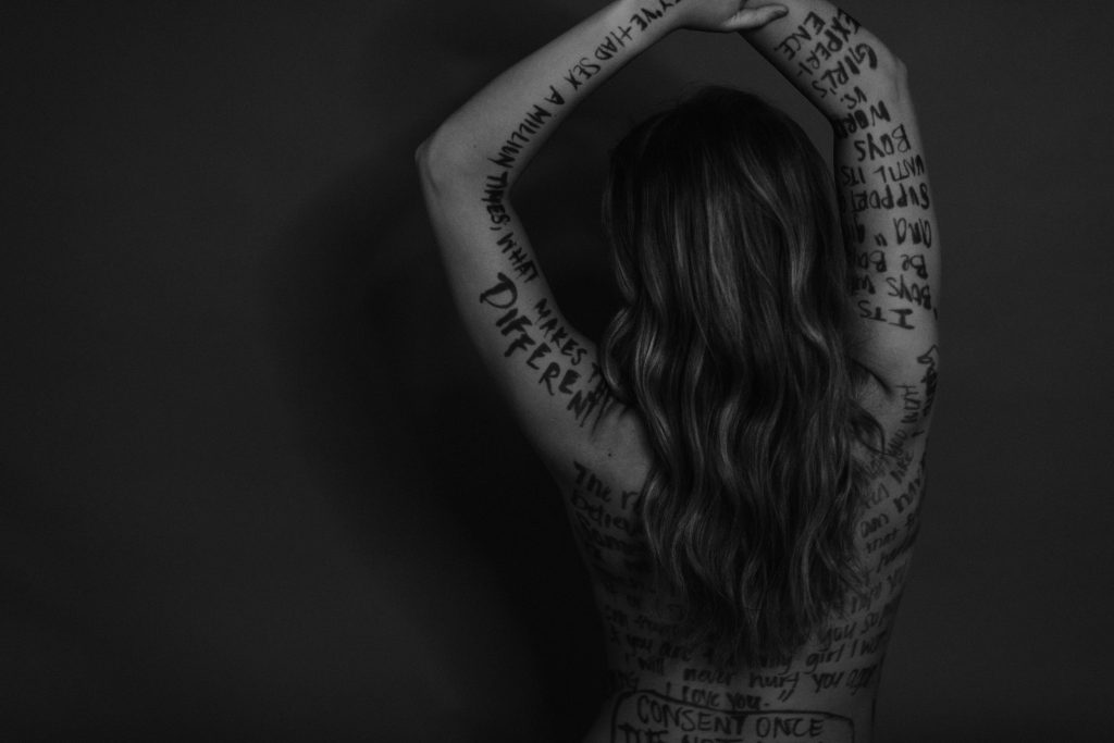 tabitha crain posing for her exhibit supporting domestic assault survivors